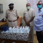 TML distributing masks and sanitisers to police men