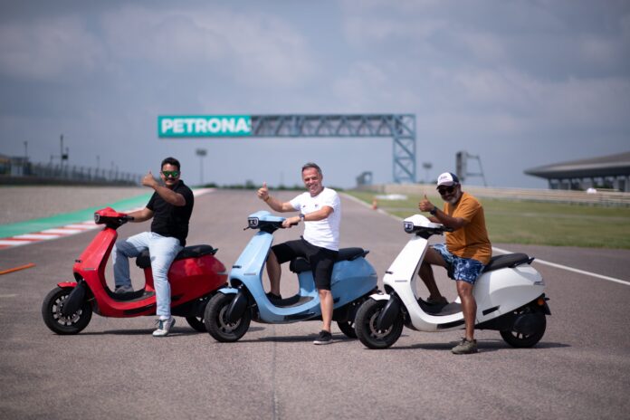 Former world champion Loris Capirossi with the Ola scooter at BIC.